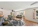 Inviting living room featuring hardwood floors, neutral walls, comfortable seating, and large window at 3246 Yukon Dr, Port Charlotte, FL 33948