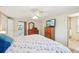 A main bedroom offers a calm space with carpet, ceiling fan, and wooden dressers near the ensuite bathroom at 3246 Yukon Dr, Port Charlotte, FL 33948