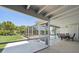 This view from the patio shows a screened in pool and the lush, green yard beyond at 3246 Yukon Dr, Port Charlotte, FL 33948