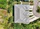Aerial view of a beautiful home's roof, landscaping, and circular drive in a golf course community at 3433 Grand Vista Ct # 102, Port Charlotte, FL 33953