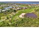 Enjoy a scenic view of a golf course community with lush landscaping, a large lake, and winding roads at 3433 Grand Vista Ct # 102, Port Charlotte, FL 33953