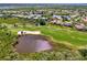 Aerial view of a beautiful golf course community with lush landscaping, lakes, golf course, and winding roads at 3433 Grand Vista Ct # 102, Port Charlotte, FL 33953