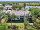 Stunning aerial view of this multi-Gathering home with lake views, surrounded by lush greenery and mature trees at 3433 Grand Vista Ct # 102, Port Charlotte, FL 33953