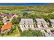 Stunning aerial view of townhomes in a golf course community featuring lush landscaping, mature trees, and lakes at 3433 Grand Vista Ct # 102, Port Charlotte, FL 33953