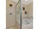 Elegant bathroom showcasing a bathtub and a walk-in shower enclosed with glass offering a luxurious experience at 3433 Grand Vista Ct # 102, Port Charlotte, FL 33953