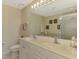 Clean bathroom featuring double sinks, a large mirror with vanity lighting, and a walk-in shower offering convenience and style at 3433 Grand Vista Ct # 102, Port Charlotte, FL 33953