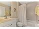 Bright bathroom featuring a shower-tub combo with tile surround and a white vanity with sink at 3433 Grand Vista Ct # 102, Port Charlotte, FL 33953