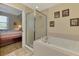 Bright bathroom with a bathtub and shower next to the main bedroom offering a relaxing and private space at 3433 Grand Vista Ct # 102, Port Charlotte, FL 33953