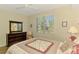 Bright bedroom with a window view, a wooden dresser and a decorative quilt offering a peaceful retreat at 3433 Grand Vista Ct # 102, Port Charlotte, FL 33953