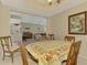 Cozy dining room featuring a table, chairs, and a beautiful painting in a well-lit space with views to the living room at 3433 Grand Vista Ct # 102, Port Charlotte, FL 33953