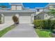 Inviting two-story townhouse featuring a two-car garage, well-maintained landscaping, and a neutral color scheme at 3433 Grand Vista Ct # 102, Port Charlotte, FL 33953