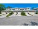 Townhome exteriors with manicured lawns, driveways, and attached garages offer convenient parking at 3433 Grand Vista Ct # 102, Port Charlotte, FL 33953