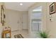 Welcoming foyer with neutral tile flooring and adjacent laundry room with washer, dryer, and overhead cabinets at 3433 Grand Vista Ct # 102, Port Charlotte, FL 33953