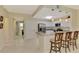 Open kitchen featuring stainless steel appliances, white cabinets, breakfast bar with stools, and seamless flow to living spaces at 3433 Grand Vista Ct # 102, Port Charlotte, FL 33953