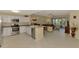 Bright open kitchen with white cabinetry, stainless steel appliances, breakfast bar, and seamless flow to the living area at 3433 Grand Vista Ct # 102, Port Charlotte, FL 33953