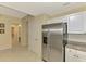 Stainless steel refrigerator and white cabinetry complete the kitchen area at 3433 Grand Vista Ct # 102, Port Charlotte, FL 33953