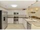 Bright kitchen features stainless steel appliances and white cabinetry at 3433 Grand Vista Ct # 102, Port Charlotte, FL 33953