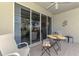 Relaxing covered lanai with tiled floor and sliding glass doors, furnished with a table and chairs at 3433 Grand Vista Ct # 102, Port Charlotte, FL 33953