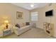Welcoming living room featuring a cozy sofa and a mounted TV creating a comfortable and inviting entertainment space at 3433 Grand Vista Ct # 102, Port Charlotte, FL 33953