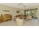 Open living area with comfortable seating and a screened lanai at 3433 Grand Vista Ct # 102, Port Charlotte, FL 33953