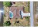 Aerial view of home showcasing roof, driveway, pool, and backyard landscaping at 39 Fairway Rd, Rotonda West, FL 33947