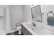 Bathroom featuring white shiplap wall, brushed hardware, gray vanity and a walk-in shower with a white curtain at 39 Fairway Rd, Rotonda West, FL 33947