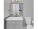 Bathroom with gray walls, light grey vanity with gray hardware and mosaic tile and toilet at 39 Fairway Rd, Rotonda West, FL 33947