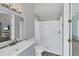 Bathroom featuring a walk-in shower, gray vanity with mosaic tile backsplash, and a bright, open design at 39 Fairway Rd, Rotonda West, FL 33947