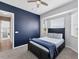 Bedroom with a navy accent wall, a dark wood bed frame, light carpet and a window with blinds at 39 Fairway Rd, Rotonda West, FL 33947