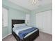 Bedroom with light blue walls and dark wood bed frame featuring a patterned comforter and a blue throw blanket at 39 Fairway Rd, Rotonda West, FL 33947