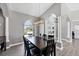 Bright dining room with dark wood table, chandelier, archways and lots of natural light at 39 Fairway Rd, Rotonda West, FL 33947