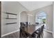 Elegant dining area with a modern chandelier, neutral walls, and a picturesque window view at 39 Fairway Rd, Rotonda West, FL 33947