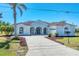 Charming single-story home boasts a well-kept lawn, beautiful landscaping, and a paved driveway leading to the garage at 39 Fairway Rd, Rotonda West, FL 33947