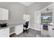 Open home office space features a built-in desk and storage with an open view to the screened lanai at 39 Fairway Rd, Rotonda West, FL 33947