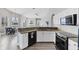 Open kitchen with granite countertops, stainless steel appliances, and breakfast bar at 39 Fairway Rd, Rotonda West, FL 33947