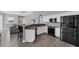 Open kitchen with white cabinets, granite countertops, stainless steel appliances, and breakfast bar at 39 Fairway Rd, Rotonda West, FL 33947