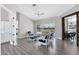 Open-concept living room with contemporary furnishings, seamless access to the lanai, and modern flooring at 39 Fairway Rd, Rotonda West, FL 33947
