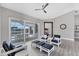 Bright living room boasts neutral tones, modern flooring, and access to the outdoor lanai with a pool view at 39 Fairway Rd, Rotonda West, FL 33947