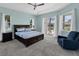Spacious main bedroom features a tray ceiling, ceiling fan, and access to the lanai at 39 Fairway Rd, Rotonda West, FL 33947
