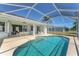 Covered patio with outdoor seating and a beautiful pool view, perfect for entertaining at 39 Fairway Rd, Rotonda West, FL 33947