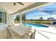 Enclosed pool with a seating area including a ceiling fan for a cool and relaxing outdoor experience at 39 Fairway Rd, Rotonda West, FL 33947