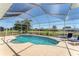 Sparkling pool inside screened enclosure, with lounge chairs for relaxing by the water and waterway at 39 Fairway Rd, Rotonda West, FL 33947