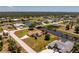 Stunning aerial view of a waterfront property featuring a meticulously landscaped yard, private pool, and serene canal access at 4 Pine Valley Ln, Rotonda West, FL 33947
