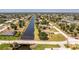 Scenic aerial view of a waterfront community with canals winding through well-manicured properties at 4 Pine Valley Ln, Rotonda West, FL 33947