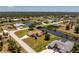 Lovely waterfront property with lush greenery, a bridge, and gorgeous views of the surrounding community at 4 Pine Valley Ln, Rotonda West, FL 33947