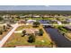 Aerial view of a well-kept waterfront home near a canal and bridge in a picturesque community at 4 Pine Valley Ln, Rotonda West, FL 33947