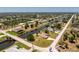 Expansive aerial view showcasing waterfront homes, canals, and a bridge in a vibrant community at 4 Pine Valley Ln, Rotonda West, FL 33947