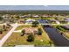 Stunning aerial view of waterfront properties, lush greenery, and a connecting bridge in a desirable community at 4 Pine Valley Ln, Rotonda West, FL 33947