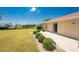 Expansive backyard featuring lush green lawn, manicured landscaping, and a tranquil view of the water, perfect for outdoor enjoyment at 4 Pine Valley Ln, Rotonda West, FL 33947
