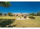 Spacious backyard showcasing well-maintained lawn, picturesque landscaping, and a serene waterfront view, ideal for relaxation and recreation at 4 Pine Valley Ln, Rotonda West, FL 33947